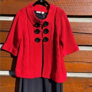 Women’s red sweater with black button detail. Size size S.